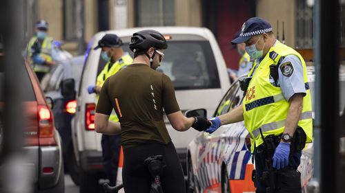 Police setup a road block to check road users identification on Enmore Road, Sydney.