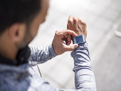 Man checking his Apple Watch