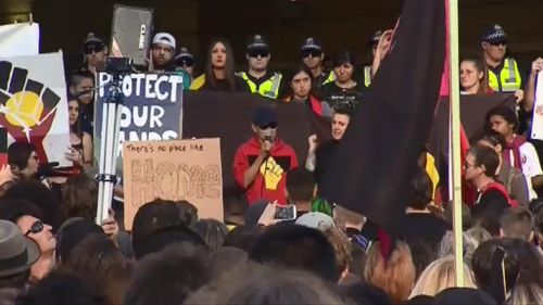 Protesters gathered underneath the clocks at Flinders Street Station. (9NEWS)