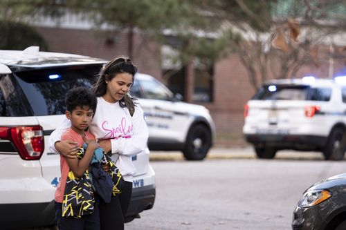 Carlos Glover, age 9,  a fourth grader at Richneck Elementary School, is held by his mother Joselin Glover as they leave the school, Friday, Jan. 6, 2023 in Newport News, Va