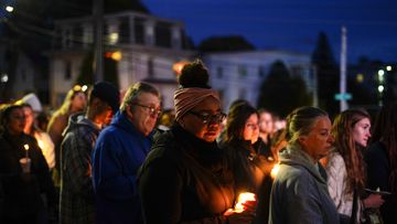 People gather at a vigil for the victims of Wednesday&#x27;s mass shootings, Sunday, Oct. 29, 2023, outside the Basilica of Saints Peter and Paul in Lewiston, Maine. 