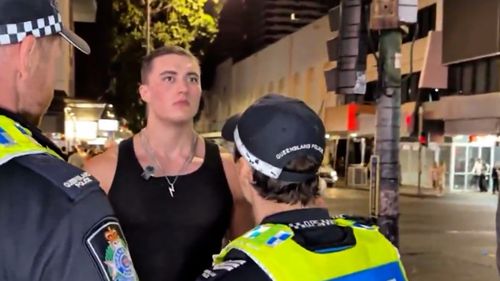 Androgenic being spoken to by police as he is being arrested.