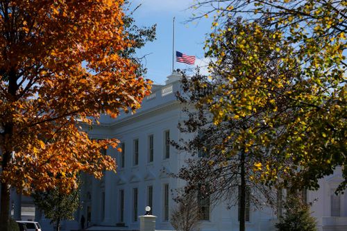 The American flag flies at half staff over the White House following the shooting.