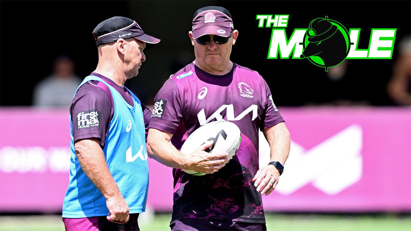 Broncos assistant coach Allan Langer and head coach Kevin Walters put their heads together at a training session.