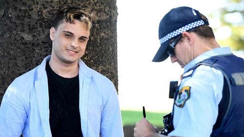 The teen smiles at the camera as he is questioned by police.