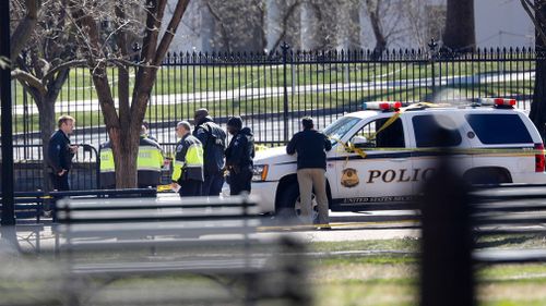Law enforcement officers gather in front of the White House in Washington D.C. on March 3, 2018. (AAP)