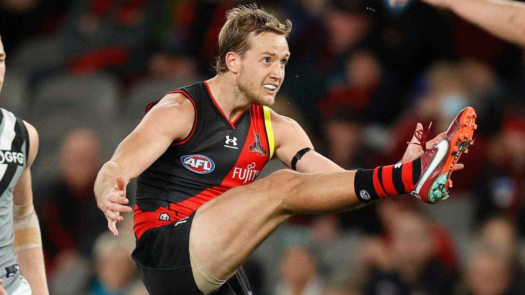 MELBOURNE, AUSTRALIA - AUGUST 14: Darcy Parish of the Bombers kicks a goal during the 2022 AFL Round 22 match between the Essendon Bombers and the Port Adelaide Power at Marvel Stadium on August 14, 2022 in Melbourne, Australia. (Photo by Michael Willson/AFL Photos)