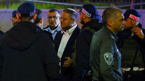Israel's Minister of National Security Itamar Ben-Gvir speaks with Israeli forces near the scene of a shooting attack in Neve Yaacov which lies on occupied land that Israel annexed to Jerusalem after the 1967 Middle East war January 27, 2023. 