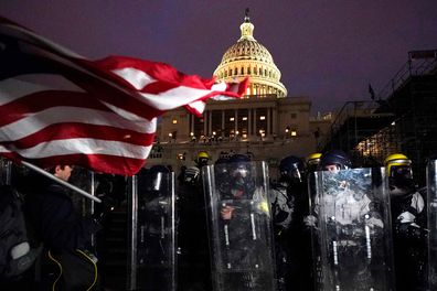 Police stand guard the day after riots at the US Capitol.