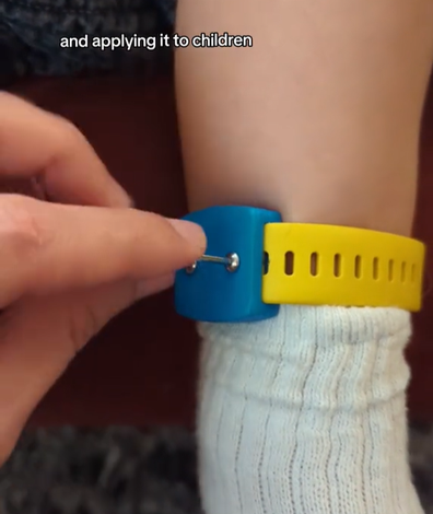 The dad recorded himself screwing the bracelet on his toddler. 