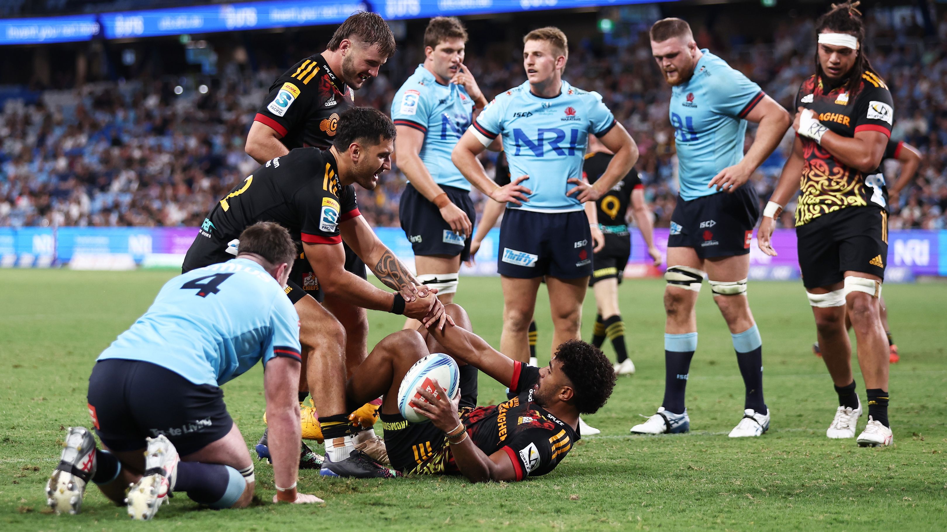 The Chiefs celebrate while the Waratahs lick their wounds after another try for Emoni Narawa.