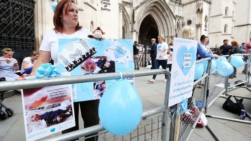Charlie Gard supporters gather outside court. (AAP)