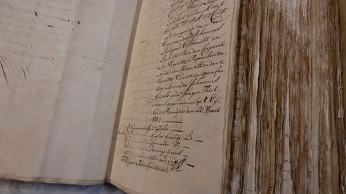 A ledger containing the names of enslaved people is shown at the National Archives in The Hague, Netherlands.