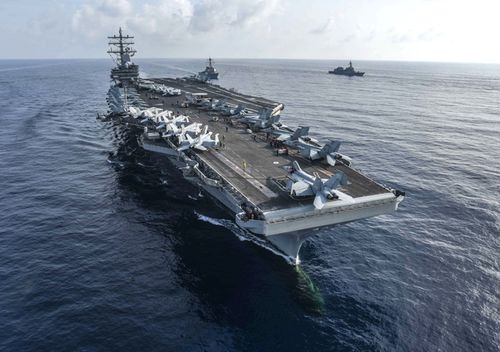 The aircraft carrier USS Ronald Reagan and the guided-missile destroyer USS Milius conduct a photo exercise with Japan Maritime Self-Defense Force ships.