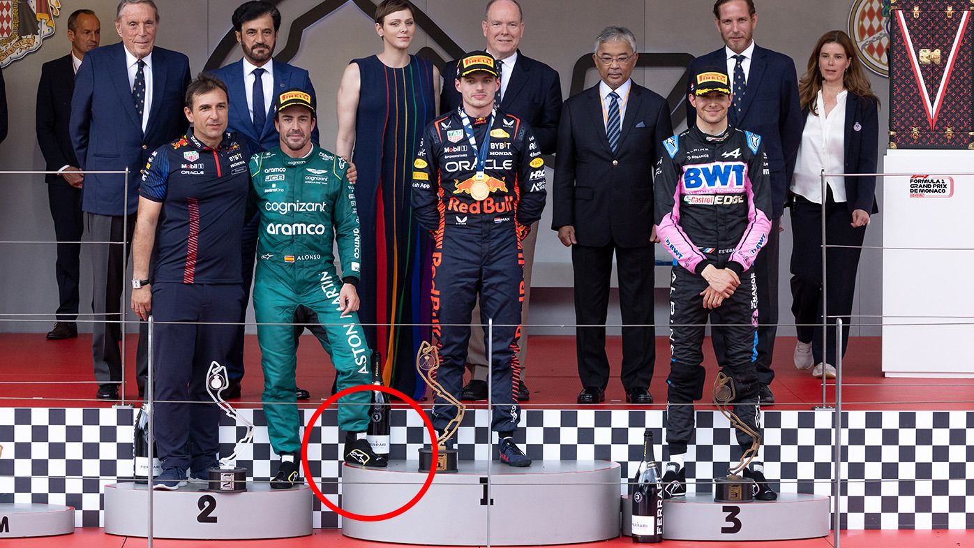 Fernando Alonso put his foot on the top step of the podium during photos after the Monaco Grand Prix.