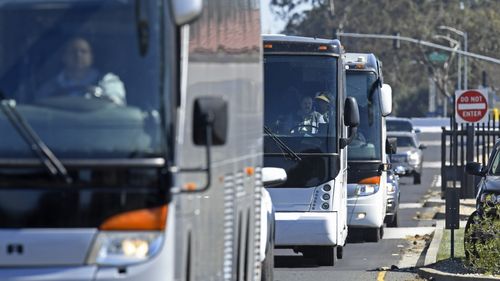 Three buses leave Travis Air Force Base carrying passengers that were aboard the Diamond Princess cruise ship.