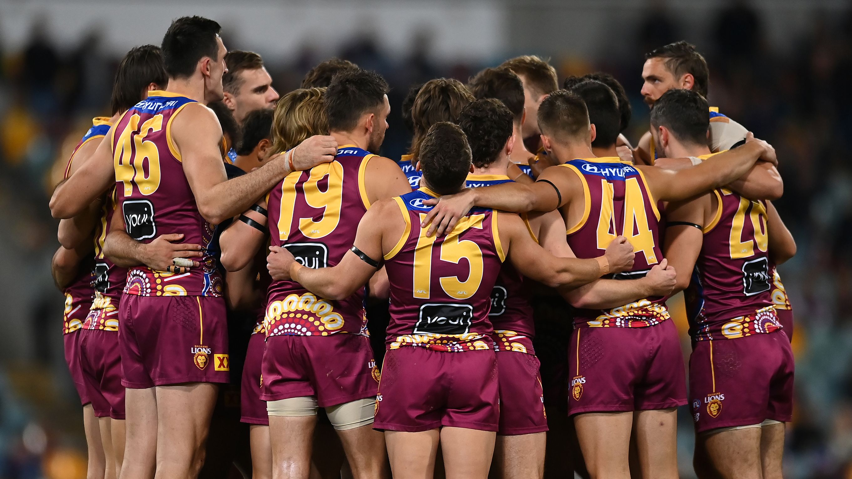 BRISBANE, AUSTRALIA - MAY 20: The Brisbane Lions huddle during the round 10 AFL match between Brisbane Lions and Gold Coast Suns at The Gabba, on May 20, 2023, in Brisbane, Australia. (Photo by Albert Perez/AFL Photos via Getty Images)