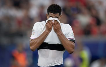 Jude Bellingham of England wipes sweat from his face during the UEFA EURO 2024 group stage match between Denmark and England at Frankfurt Arena on June 20, 2024 in Frankfurt am Main, Germany. (Photo by Visionhaus/Getty Images)