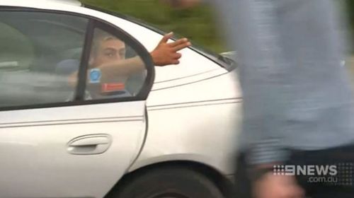A 30-year old man charged with concealing a serious indictable offence gestures to a 9NEWS crew. (9NEWS)