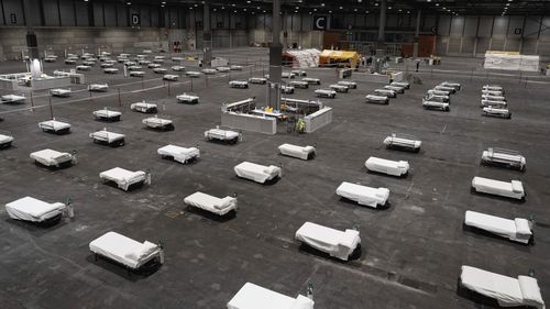 In this photo provided by Comunidad de Madrid, beds for COVID-19 patients are placed at IFEMA convention center in Madrid, Spain on Saturday, March 21, 2020.