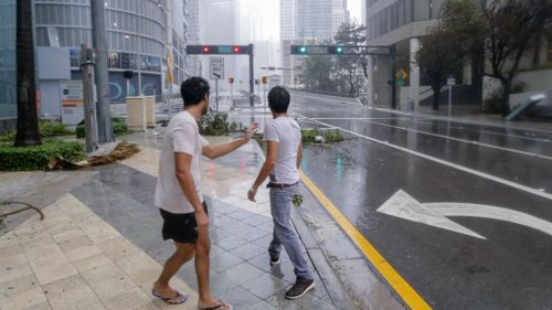 Men venture outside as Hurricane Irma strikes in Miami. (AAP)
