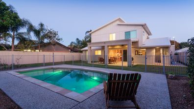 Modern home at dusk with swimming pool