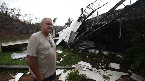  Dave McInerney beside the wreckage of his business at Shute Harbour. (AAP)