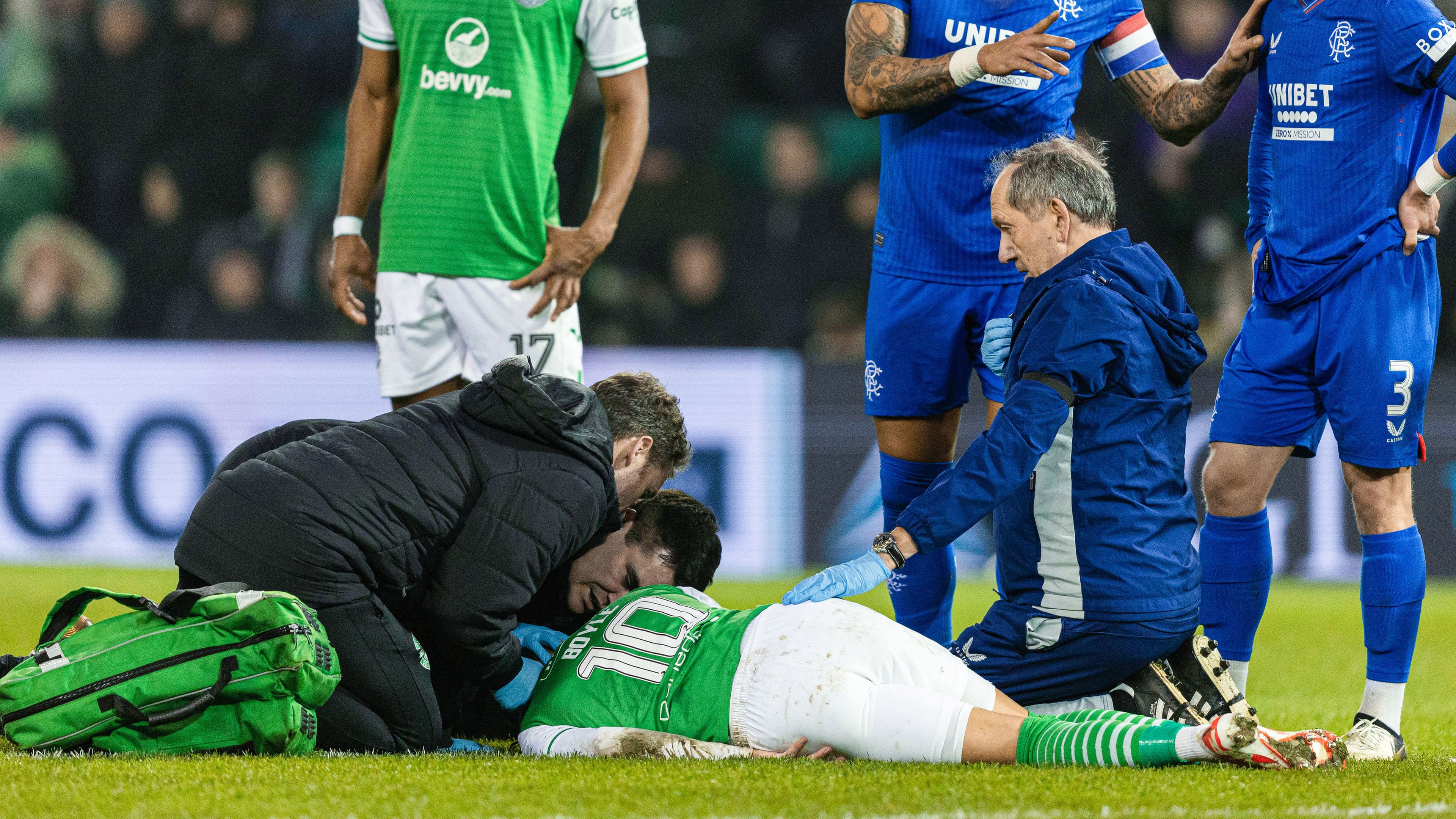 Hibernian&#x27;s Martin Boyle receives medical treatment after going down injured.