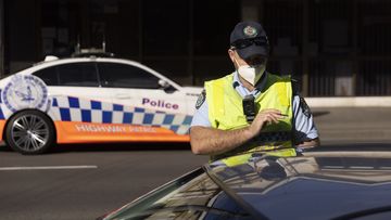 Police check drivers on Enmore Road as part of the enforcement of Public Health orders in Sydney.