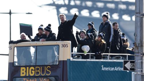 Philadelphia Eagles NFL football team head coach Doug Pederson points to the crowd gathered during the Super Bowl LII victory parade. (AAP)