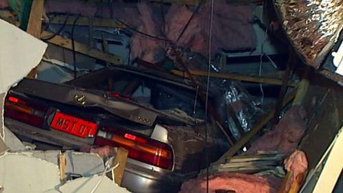 A crane will be brought in to remove a car that smashed into a family home. (9NEWS)