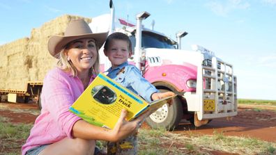 Danyelle Haigh with her son and his favourite book in front of her truck 'pink bits'
