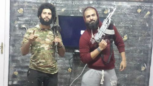 Suhan Rahman (right) with poses with a silver-plated AK47. (Facebook)