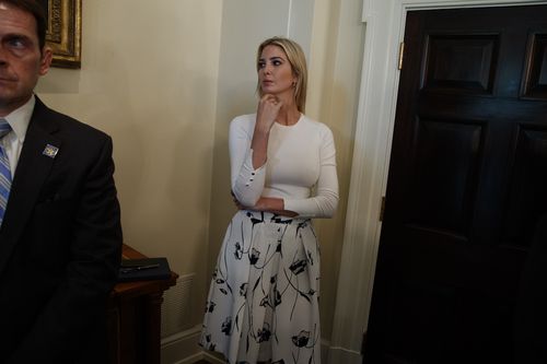 Ivanka Trump watches on as her father talks about the executive order. Picture: AAP