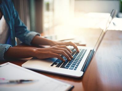 woman typing on laptop. 