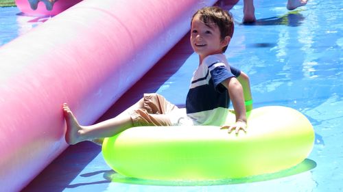 Melbournians are cooling down with a giant waterslide. (AAP)