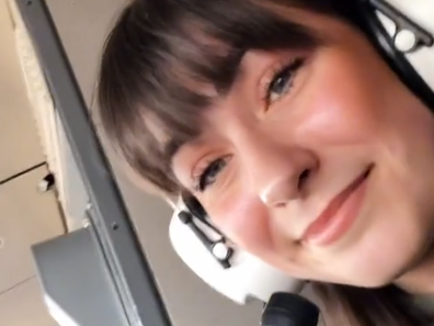 Aurora Torres sitting in the cockpit of the plane.