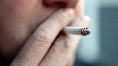 A man smokes a cigarette. North Sydney council has voted in a smoking ban across the entire CBD.