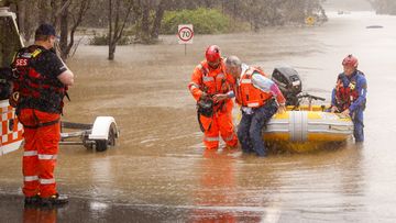 A man is rescued from his car by State Emergency Service workers in Windsor, Sydney.