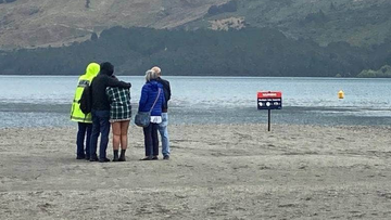 Jonathan Jordan Young&#x27;s parents, brother and fiance watch on as police divers look for his body in Lake Wakatipu.