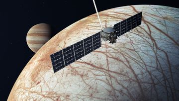 This illustration shows Europa Clipper performing a flyby of the icy moon, with Jupiter in the background.