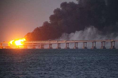 Flame and smoke rise fron Crimean Bridge connecting Russian mainland and Crimean peninsula over the Kerch Strait, in Kerch, Crimea, Saturday, Oct. 8, 2022. 