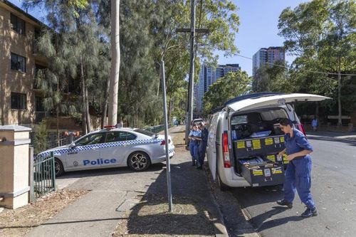 Police attend a block of units at 42-44 Newman Street, Merrylands, where a 44-year-old man died from a gunshot wound early Saturday morning.