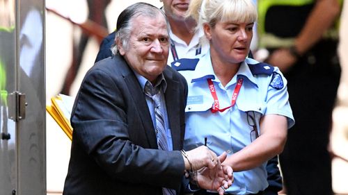 Gregory Davies is escorted by prison courts to The Supreme Court on Thursday. (AAP)