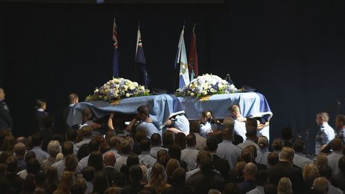 The coffins of Constables Rachel McCrow and Matthew Arnold at the memorial.