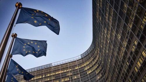 European flags wave in front of the Berlaymont building in Brussels.