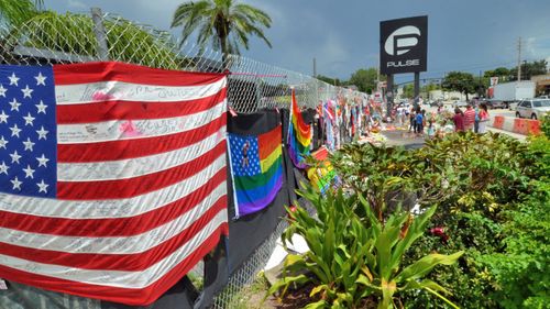 People pay tribute to the victims of one of the deadliest mass shooting in modern US history at Pulse, a gay club, in Orlando, Florida. (AP).
