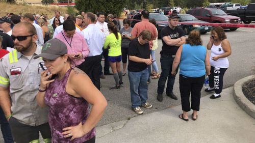 Parents gather in the parking lot behind Freeman High School in Rockford, Wash. to wait for their kids, after a deadly shooting at the high school Wednesday, Sept. 13, 2017. (Dan Pelle/The Spokesman-Review via AP)