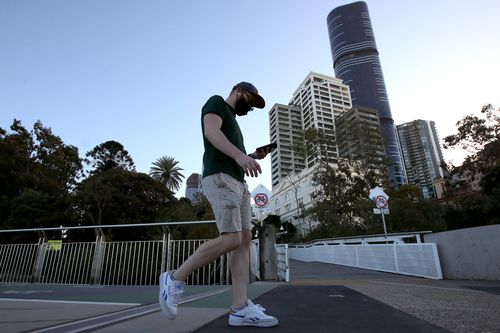 People walking near the Brisbane CBD after lockdown began on July 31, 2021 in Brisbane.