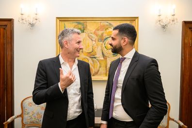 Comedian Adam Hills (L) speaks with Founder of "Street Side Medics" Dr Daniel Nour at Australia House on May 04, 2023 in London, England. A number of high profile Australian figures have been chosen to represent Australia at the Coronation of King Charles III.